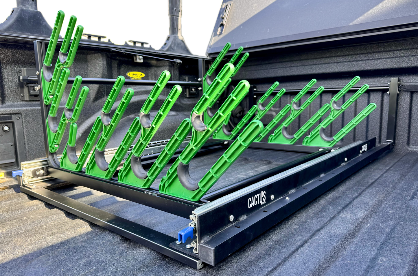 Cactus Rack holding skis for pickup truck bed with sliding base